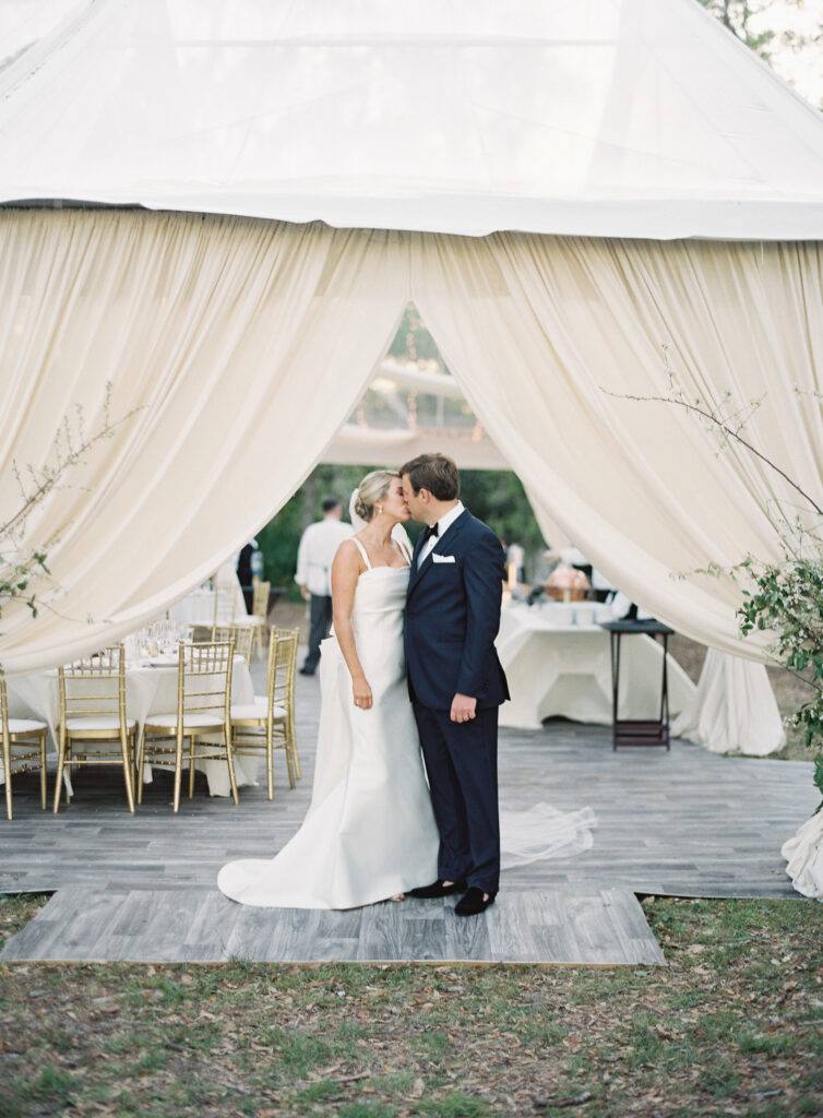 bride and groom outdoor wedding tent